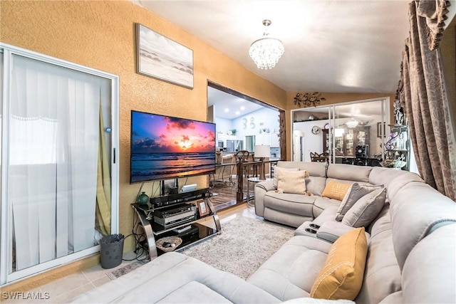 living room with a notable chandelier and vaulted ceiling