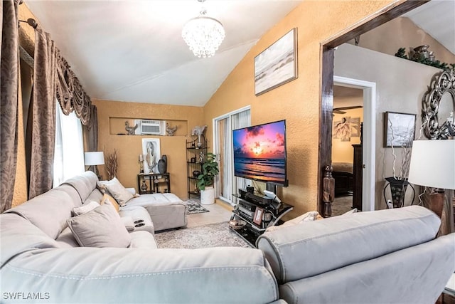 living room with a chandelier, an AC wall unit, and vaulted ceiling