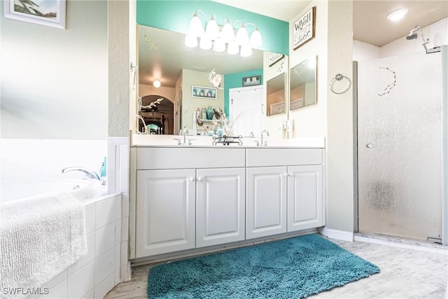 bathroom with vanity and independent shower and bath