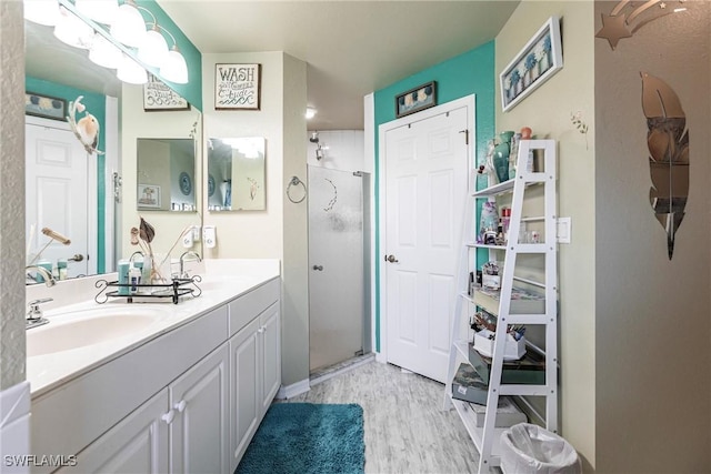 bathroom featuring hardwood / wood-style floors, vanity, and a shower with shower door