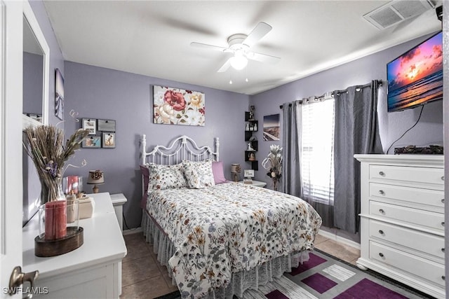 tiled bedroom with ceiling fan and multiple windows