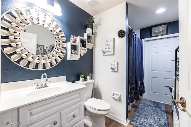 bathroom featuring a shower with shower curtain, vanity, toilet, and wood-type flooring