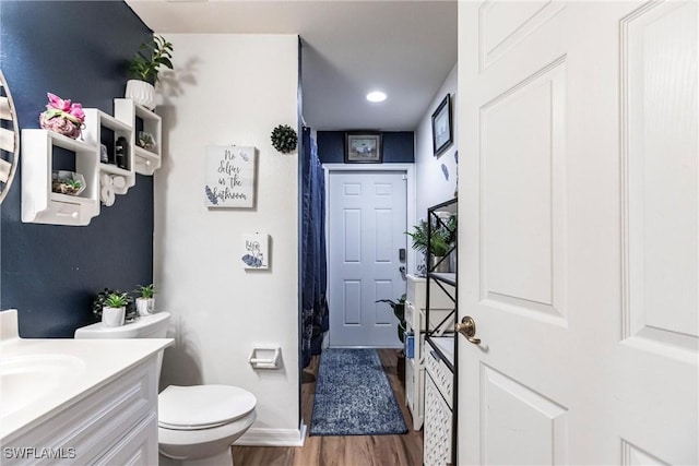 bathroom featuring hardwood / wood-style floors, vanity, and toilet