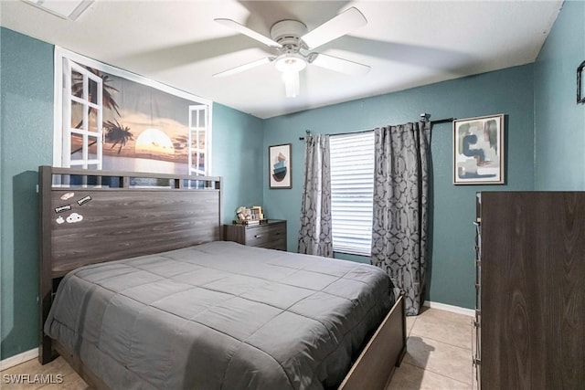 tiled bedroom featuring ceiling fan