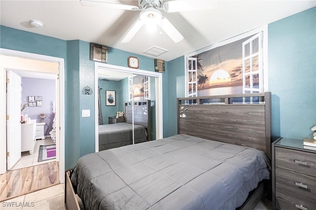 bedroom featuring light tile patterned floors, a closet, and ceiling fan