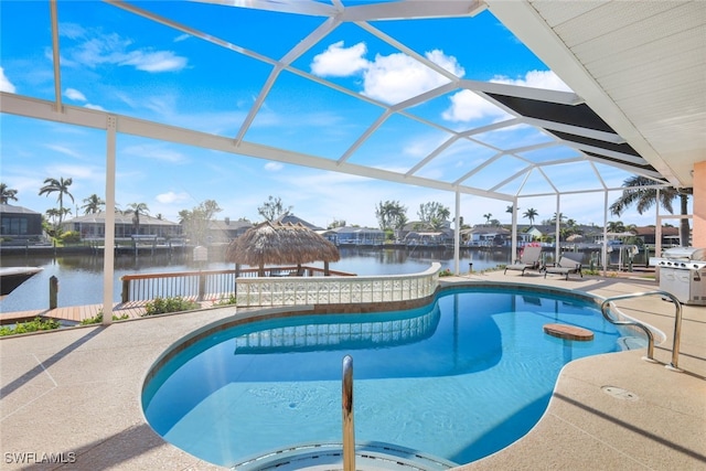 view of pool featuring glass enclosure, a patio area, area for grilling, and a water view