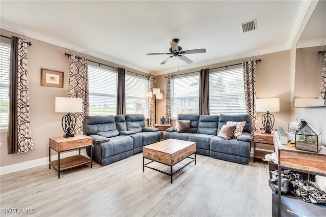 living room featuring crown molding, light hardwood / wood-style floors, and ceiling fan