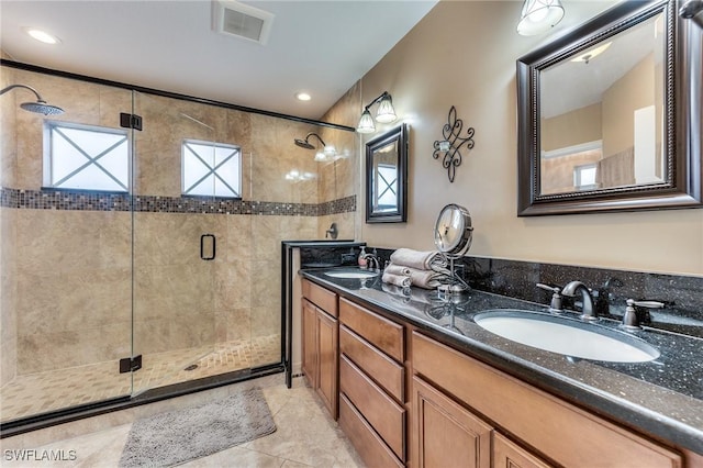 bathroom with vanity, an enclosed shower, and tile patterned floors