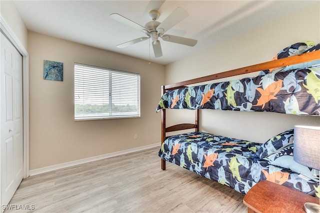 bedroom featuring ceiling fan, light hardwood / wood-style floors, and a closet