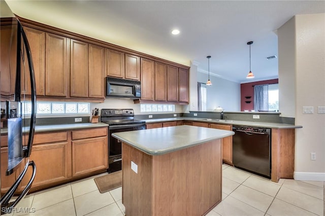 kitchen with light tile patterned floors, a kitchen island, a sink, black appliances, and decorative light fixtures