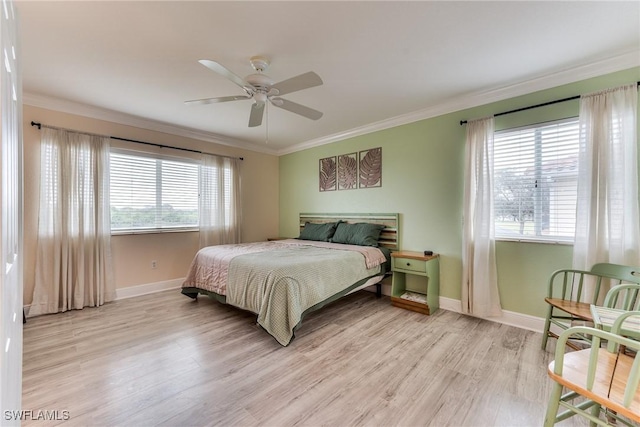 bedroom featuring ornamental molding, ceiling fan, and light wood-type flooring