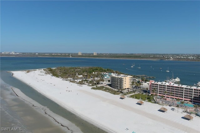 birds eye view of property featuring a beach view and a water view