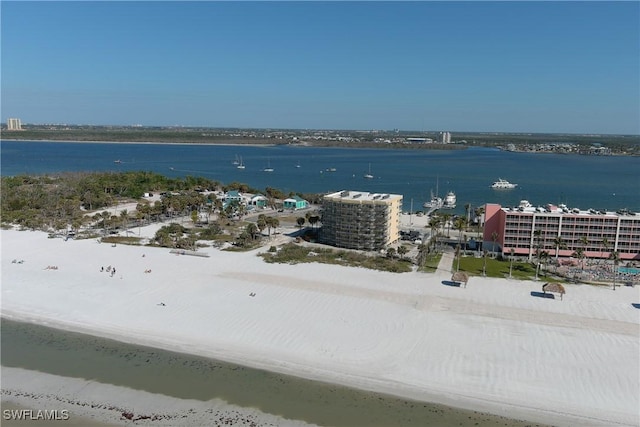 birds eye view of property featuring a beach view and a water view