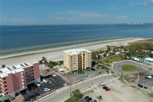 bird's eye view with a water view and a beach view