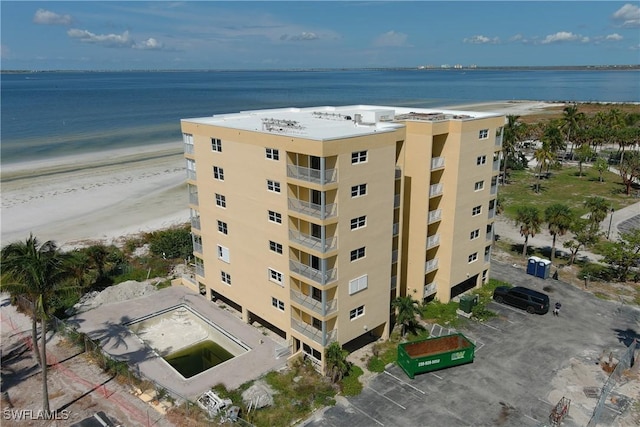 aerial view with a water view and a view of the beach