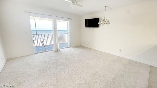 100 Estero Blvd Unit 434, Fort Myers Beach, FL 33931 - empty room featuring a chandelier, a ceiling fan, light carpet, and baseboards