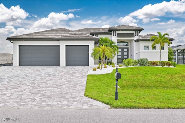 prairie-style home with a garage and a front yard