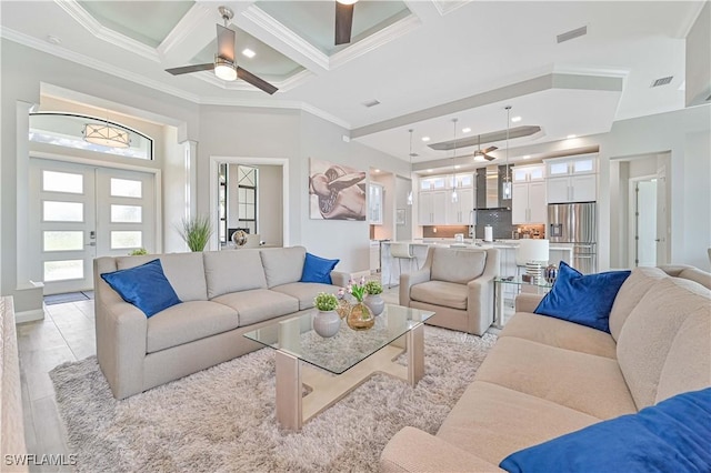 living room featuring coffered ceiling, ceiling fan, crown molding, beam ceiling, and french doors