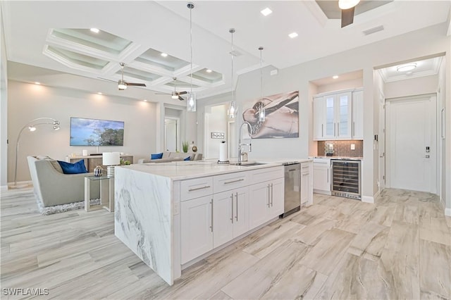 kitchen with white cabinetry, sink, beverage cooler, and ceiling fan