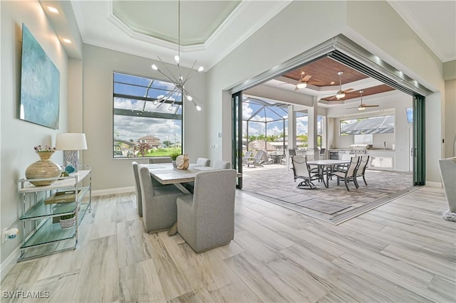 dining room featuring crown molding, ceiling fan, a raised ceiling, and light hardwood / wood-style flooring