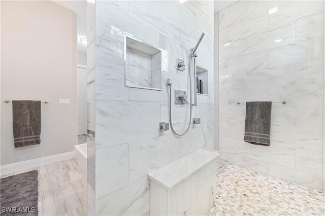 bathroom featuring a tile shower