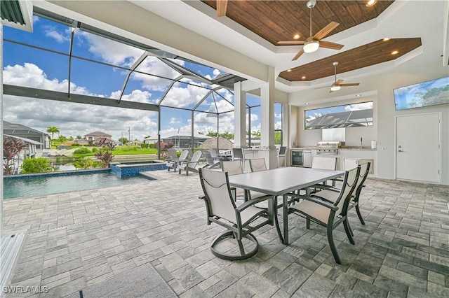 view of patio with a swimming pool with hot tub, ceiling fan, area for grilling, and glass enclosure