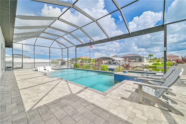 view of swimming pool with a water view, an in ground hot tub, a lanai, and a patio area