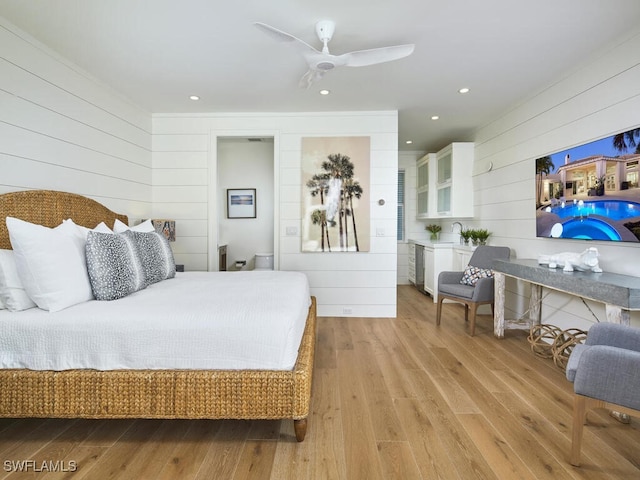 bedroom with sink and light wood-type flooring