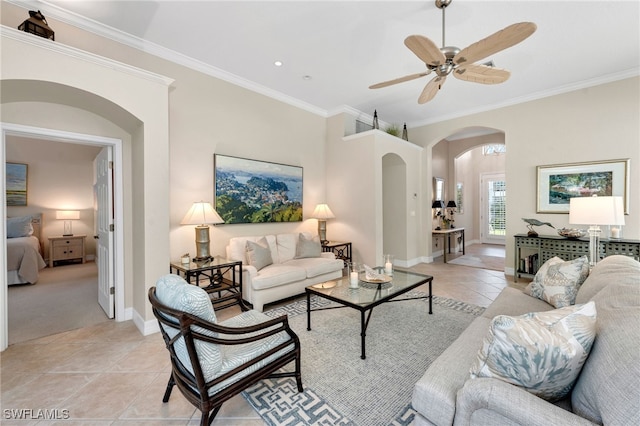 living room featuring ceiling fan, light tile patterned floors, and crown molding