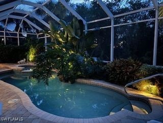 view of pool with glass enclosure