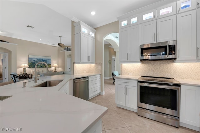 kitchen featuring white cabinetry, ceiling fan, stainless steel appliances, light tile patterned flooring, and sink