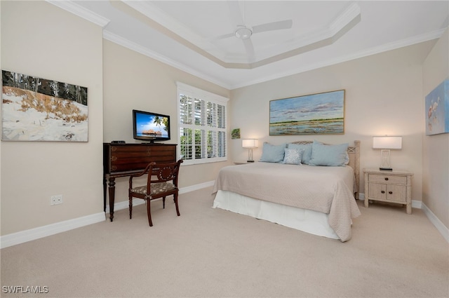 carpeted bedroom featuring ceiling fan, crown molding, and a tray ceiling