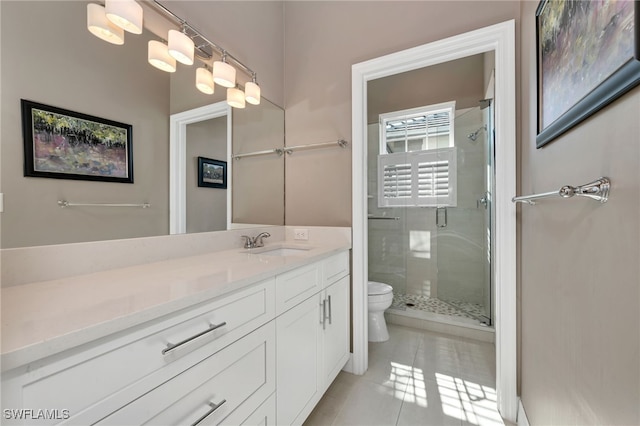 bathroom featuring toilet, vanity, tile patterned flooring, and an enclosed shower