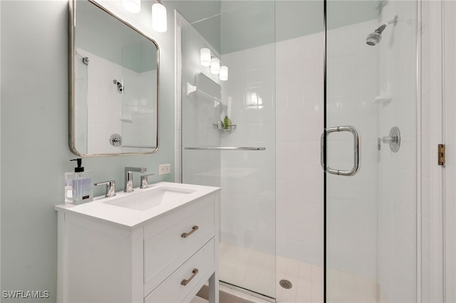 bathroom with walk in shower and vanity