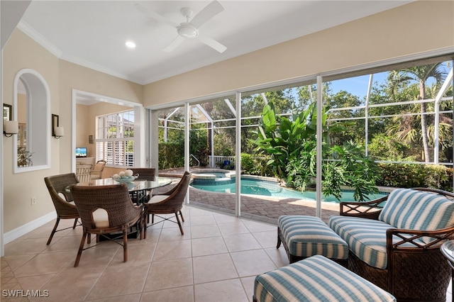 sunroom with ceiling fan and a pool