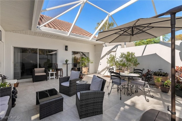 view of patio / terrace featuring an outdoor living space and glass enclosure