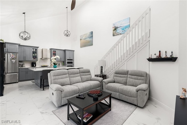 living room featuring high vaulted ceiling and a notable chandelier