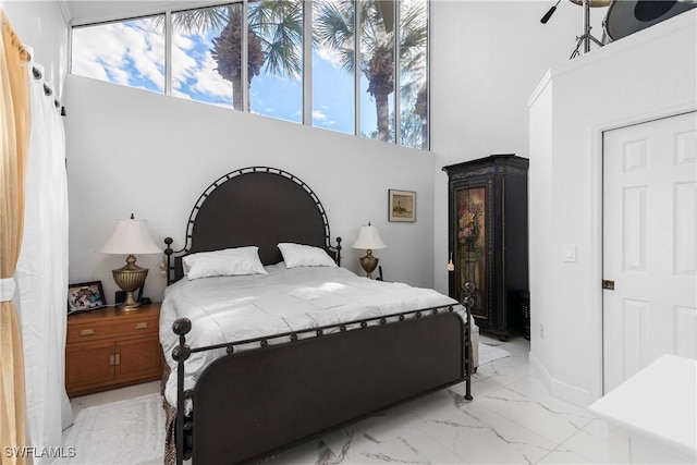 bedroom featuring a towering ceiling