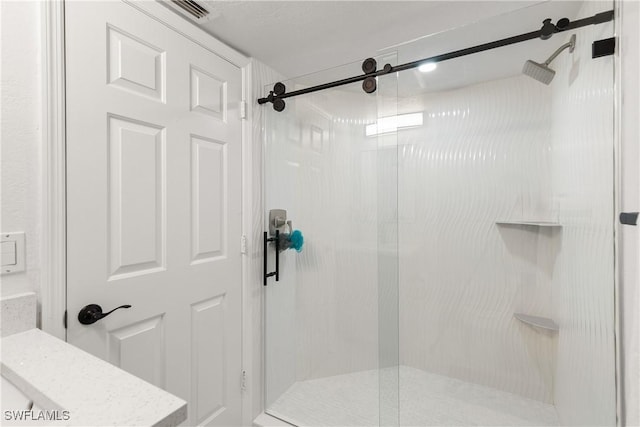 bathroom with a shower with door