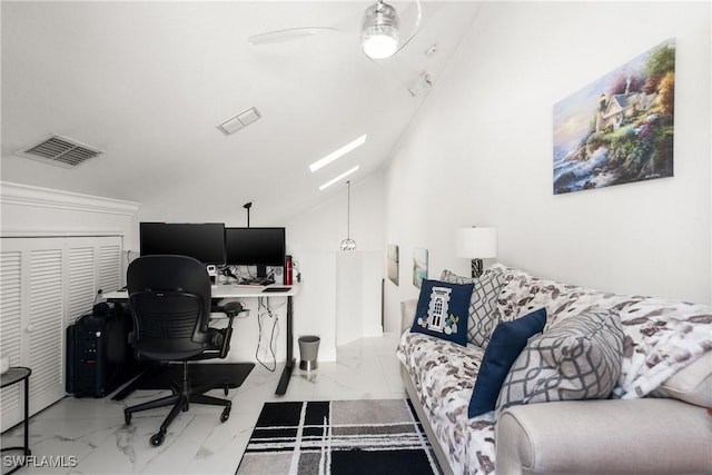 office area with lofted ceiling with skylight