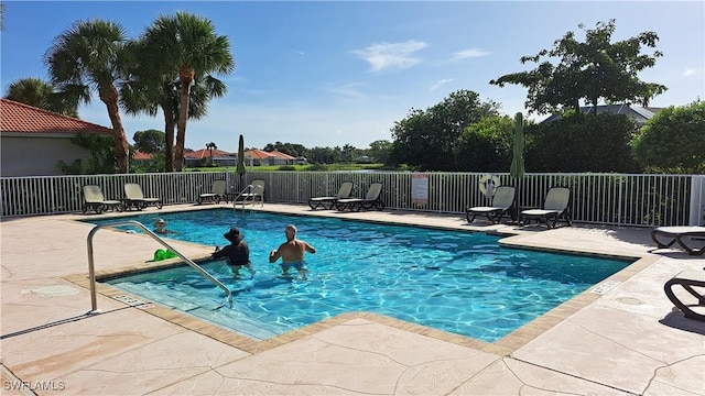 view of swimming pool featuring a patio area