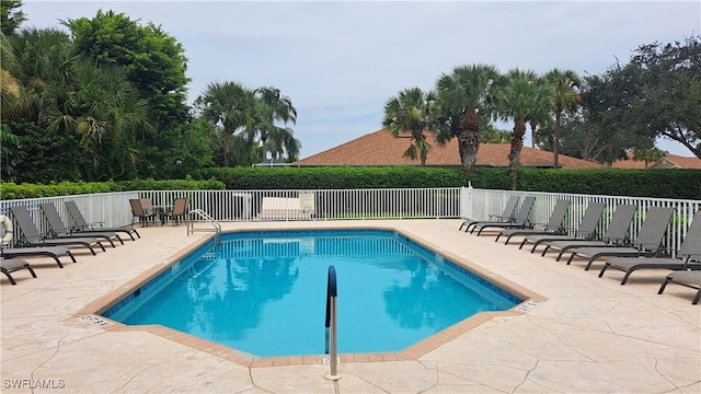 view of swimming pool featuring a patio area