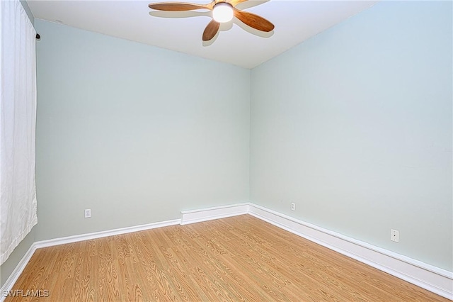 empty room with hardwood / wood-style flooring and ceiling fan