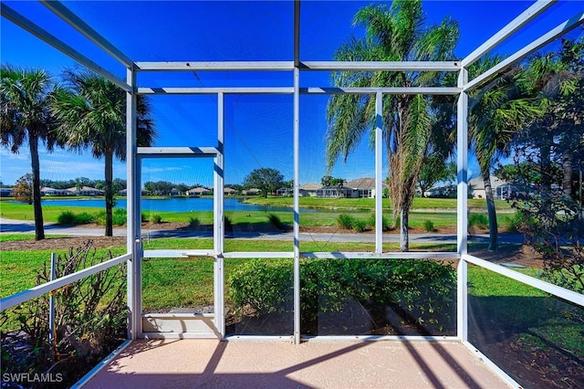 unfurnished sunroom with a water view