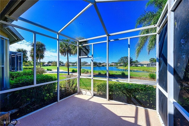 unfurnished sunroom featuring a water view