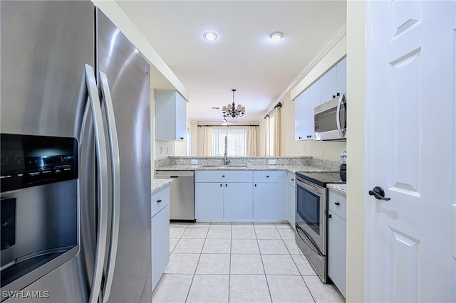 kitchen featuring appliances with stainless steel finishes, sink, light stone counters, ornamental molding, and a chandelier