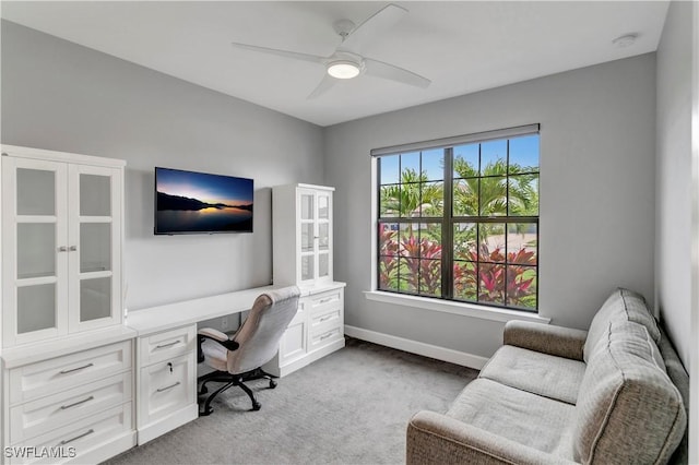 home office with ceiling fan and light colored carpet