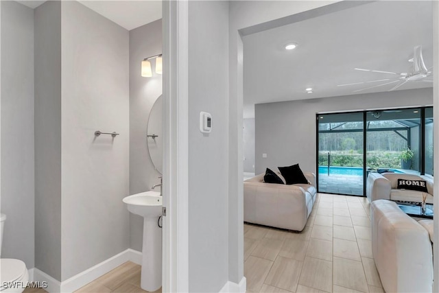 bathroom featuring ceiling fan and toilet