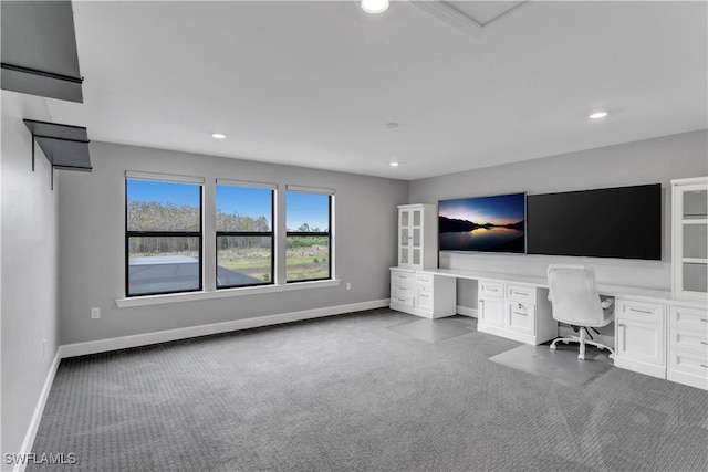 unfurnished office featuring light carpet and built in desk