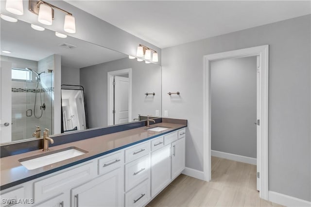 bathroom with walk in shower and vanity